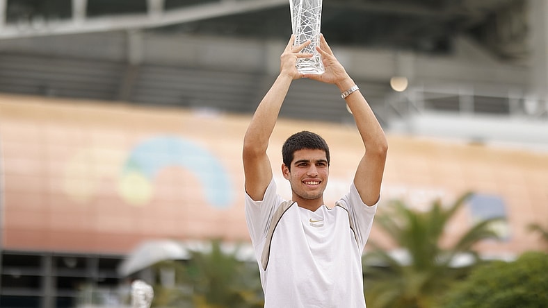 Apr 3, 2022; Miami Gardens, FL, USA; Carlos Alcaraz (ESP) poses for a portrait while holding the Butch Buchholz Championship Trophy after winning the men's singles final in the Miami Open at Hard Rock Stadium. Mandatory Credit: Geoff Burke-USA TODAY Sports
