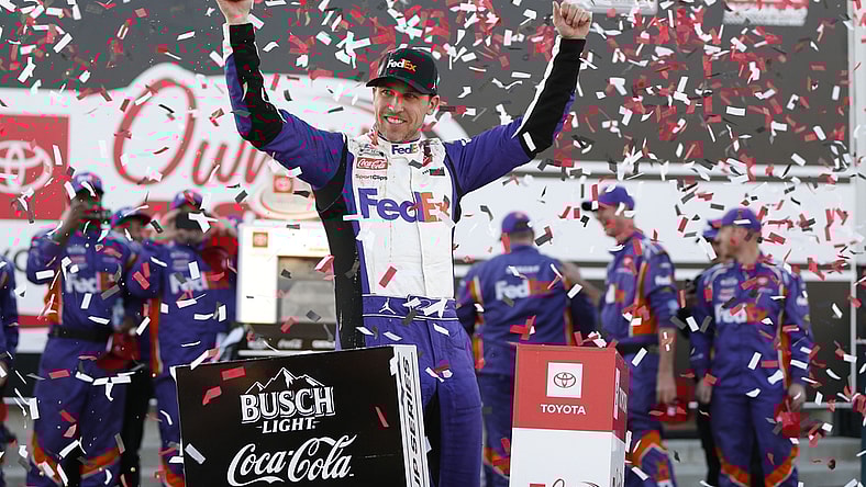 Apr 3, 2022; Richmond, Virginia, USA; NASCAR Cup Series driver Denny Hamlin (11) celebrates in Victory Lane after winning the Toyota Owners 400 at Richmond International Raceway. Mandatory Credit: Amber Searls-USA TODAY Sports