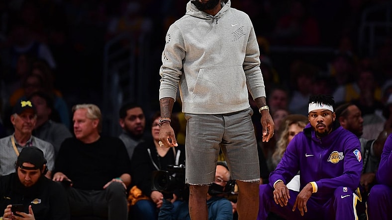 Apr 3, 2022; Los Angeles, California, USA; Los Angeles Lakers forward LeBron James watches game action against the Denver Nuggets during the first half at Crypto.com Arena. Mandatory Credit: Gary A. Vasquez-USA TODAY Sports