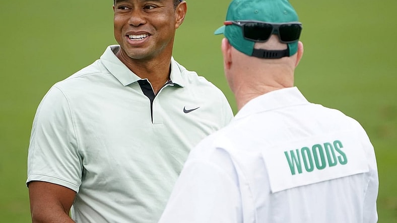Apr 5, 2022; Augusta, Georgia, USA; Tiger Woods talks with hid caddie, Joe LaCava, while hitting balls at the practice facility during a practice round of The Masters golf tournament at Augusta National Golf Club. Mandatory Credit: Danielle Parhizkaran-Augusta Chronicle/USA TODAY Network

Golf Masters Tournament Practice Round