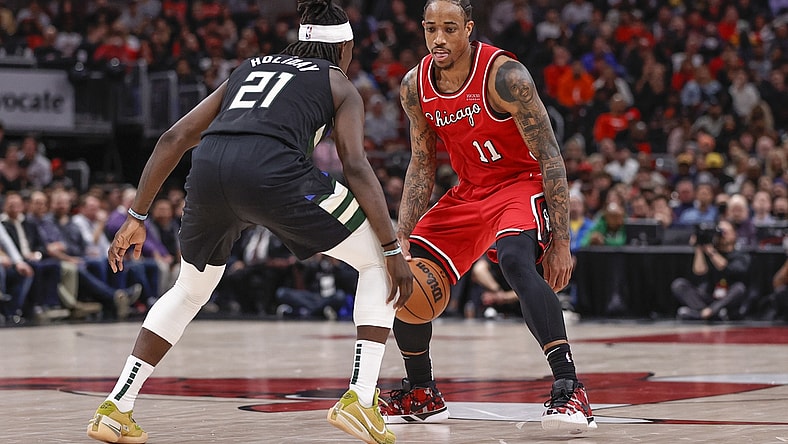Apr 5, 2022; Chicago, Illinois, USA; Chicago Bulls forward DeMar DeRozan (11) handles the ball defended by Milwaukee Bucks guard Jrue Holiday (21) during the second half at United Center. Mandatory Credit: Kamil Krzaczynski-USA TODAY Sports