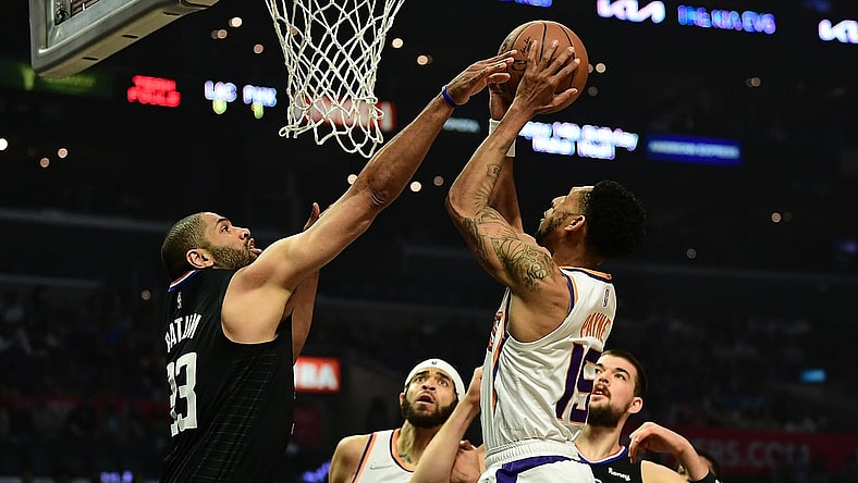 Apr 6, 2022; Los Angeles, California, USA;  Phoenix Suns guard Cameron Payne (15) shoots against Los Angeles Clippers forward Nicolas Batum (33) during the first half at Crypto.com Arena. Mandatory Credit: Gary A. Vasquez-USA TODAY Sports