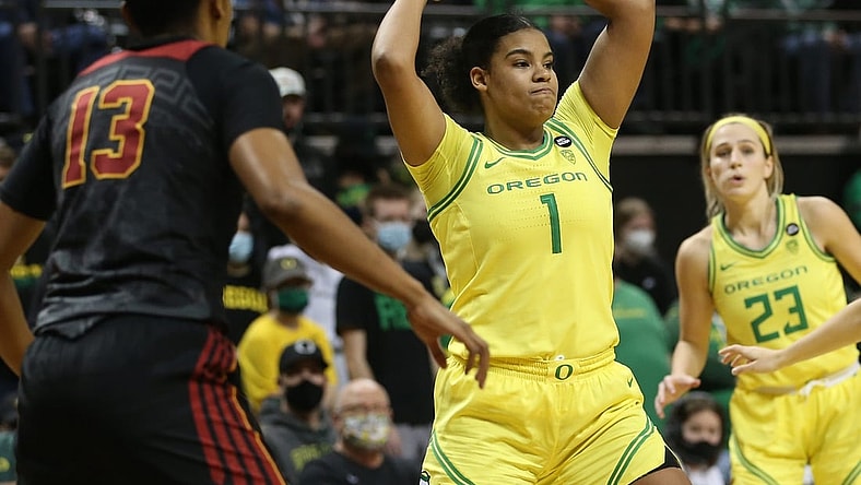 Oregon's Nyara Sabally, center, passes the ball out of the key against USC during the second half Jan. 30, 2022.

Syndication The Register Guard