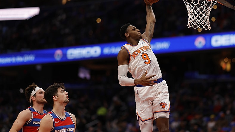 Apr 8, 2022; Washington, District of Columbia, USA; New York Knicks guard RJ Barrett (9) dunks the ball as Washington Wizards forward Deni Avdija (9) looks on in the second quarter at Capital One Arena. Mandatory Credit: Geoff Burke-USA TODAY Sports