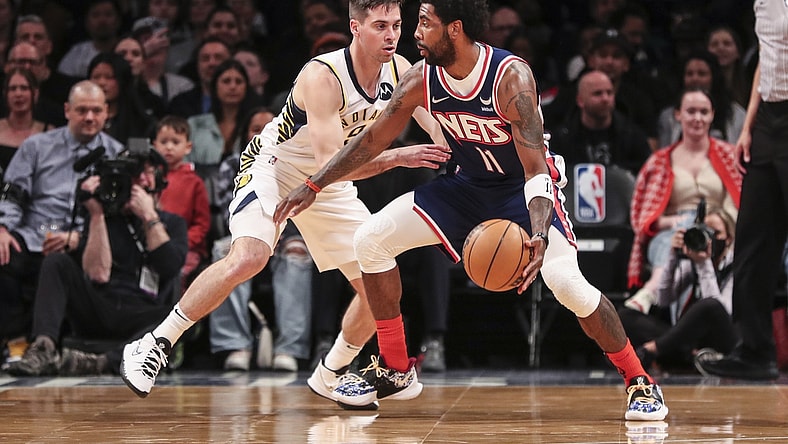 Apr 10, 2022; Brooklyn, New York, USA;  Brooklyn Nets guard Kyrie Irving (11) looks to drive past Indiana Pacers guard T.J. McConnell (9) in the first quarter at Barclays Center. Mandatory Credit: Wendell Cruz-USA TODAY Sports