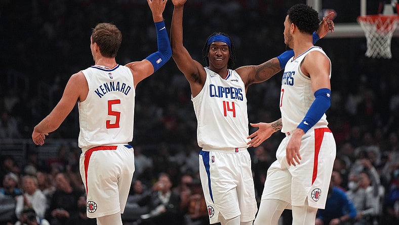 Apr 10, 2022; Los Angeles, California, USA; LA Clippers guard Luke Kennard (5), guard Terance Mann (14) and guard Amir Coffey (7) celebrate in the first half against the Oklahoma City Thunder at Crypto.com Arena. Mandatory Credit: Kirby Lee-USA TODAY Sports