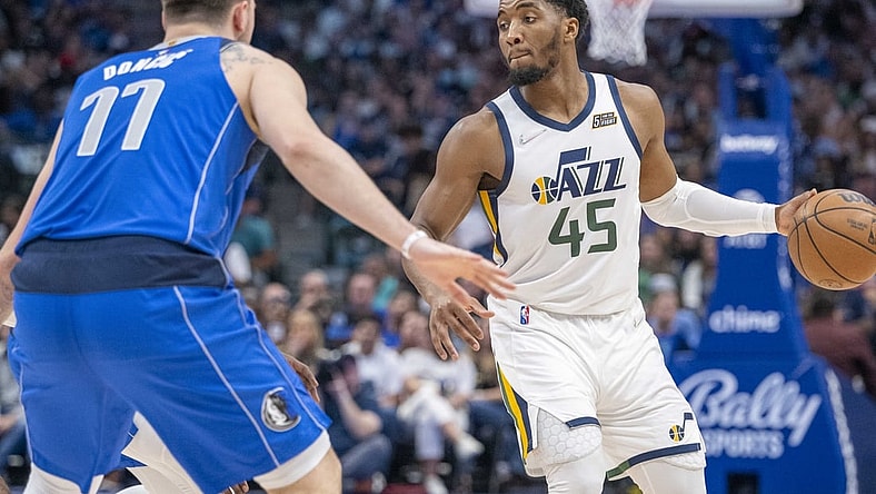 Mar 27, 2022; Dallas, Texas, USA; Dallas Mavericks guard Luka Doncic (77) guards Utah Jazz guard Donovan Mitchell (45) during the game at the American Airlines Center. Mandatory Credit: Jerome Miron-USA TODAY Sports