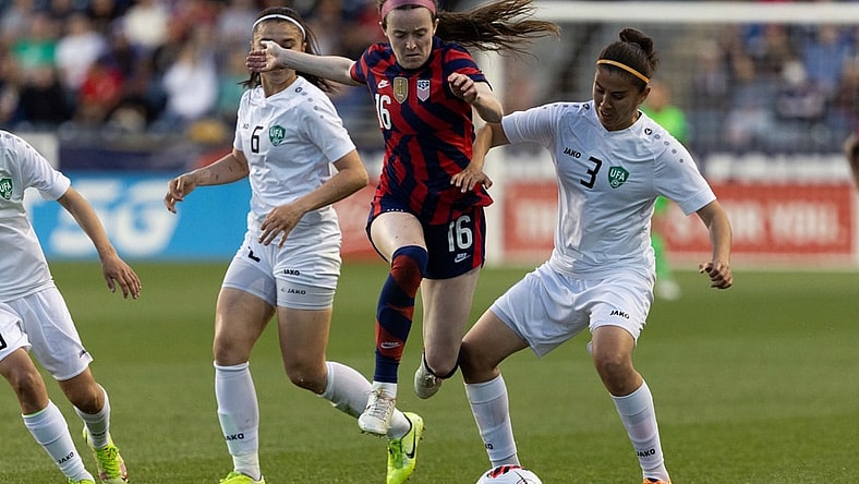 Apr 12, 2022; Chester, Pennsylvania, USA; United States midfielder Rose Lavelle (16) leaps over the defense of Uzbekistan defender Kuchkarova Ugiloy (3) during the first half of an international friendly women's soccer match at Subaru Park. Mandatory Credit: Bill Streicher-USA TODAY Sports