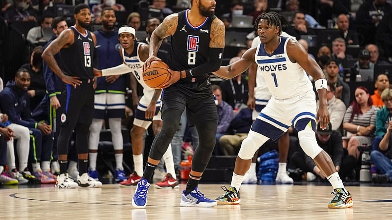 Apr 12, 2022; Minneapolis, Minnesota, USA;  Los Angeles Clippers forward Marcus Morris (8) controls the ball as Minnesota Timberwolves guard Anthony Edwards (1) defends during the first quarter of a play-in game at Target Center. Mandatory Credit: Nick Wosika-USA TODAY Sports