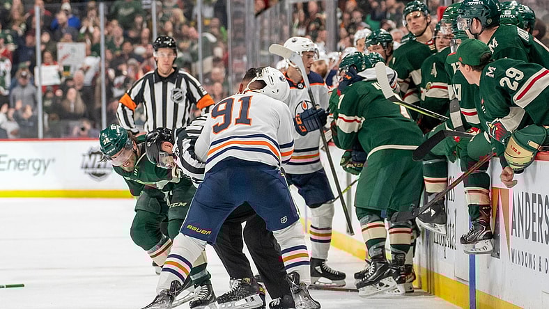 Apr 12, 2022; Saint Paul, Minnesota, USA; Minnesota Wild right wing Ryan Hartman (38) and Edmonton Oilers left wing Evander Kane (91) fight in front of the benches in the third period at Xcel Energy Center. Mandatory Credit: Matt Blewett-USA TODAY Sports