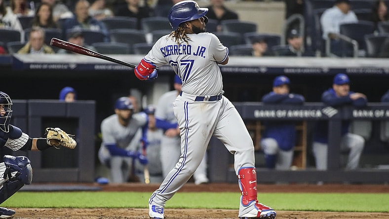 Apr 13, 2022; Bronx, New York, USA;  Toronto Blue Jays first baseman Vladimir Guerrero Jr. (27) hits a two run home run in the third inning against the New York Yankees at Yankee Stadium. Mandatory Credit: Wendell Cruz-USA TODAY Sports