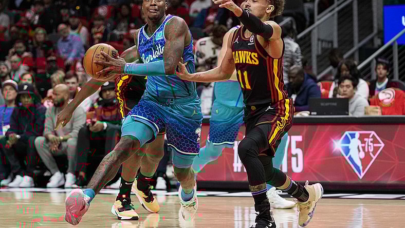 Apr 13, 2022; Atlanta, Georgia, USA; Charlotte Hornets guard Terry Rozier (3) drives to the basket against Atlanta Hawks guard Trae Young (11) during the first half at State Farm Arena. Mandatory Credit: Dale Zanine-USA TODAY Sports