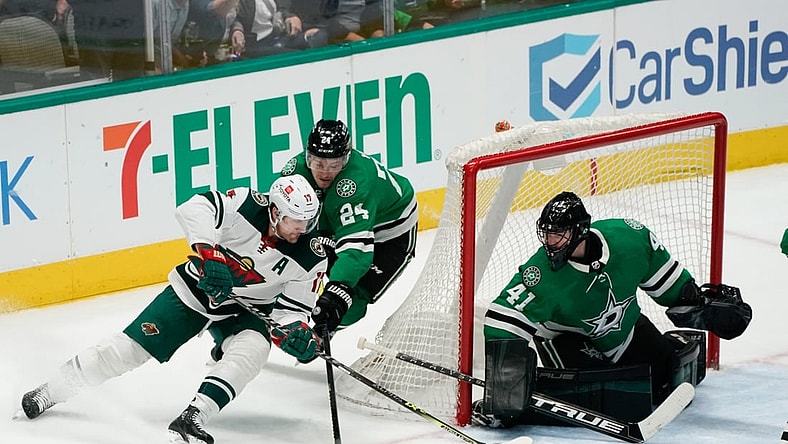 Apr 14, 2022; Dallas, Texas, USA;  Dallas Stars center Roope Hintz (24)defends Minnesota Wild left wing Marcus Foligno (17) during the third period at American Airlines Center. Mandatory Credit: Chris Jones-USA TODAY Sports