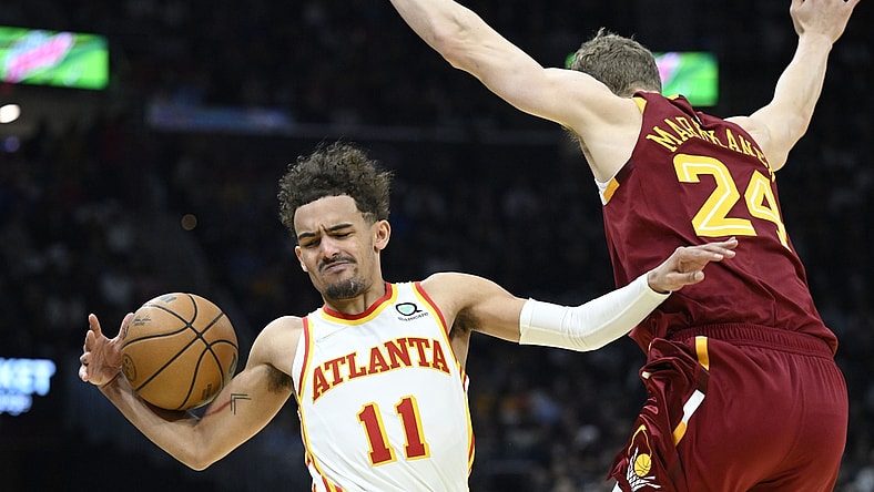 Apr 15, 2022; Cleveland, Ohio, USA; Cleveland Cavaliers forward Lauri Markkanen (24) defends Atlanta Hawks guard Trae Young (11) in the second quarter at Rocket Mortgage FieldHouse. Mandatory Credit: David Richard-USA TODAY Sports