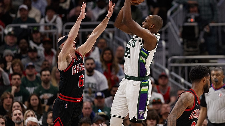 Apr 17, 2022; Milwaukee, Wisconsin, USA; Milwaukee Bucks forward Khris Middleton (22) shoots against Chicago Bulls guard Alex Caruso (6) during the fourth quarter during game one of the first round for the 2022 NBA playoffs at Fiserv Forum. Mandatory Credit: Jeff Hanisch-USA TODAY Sports