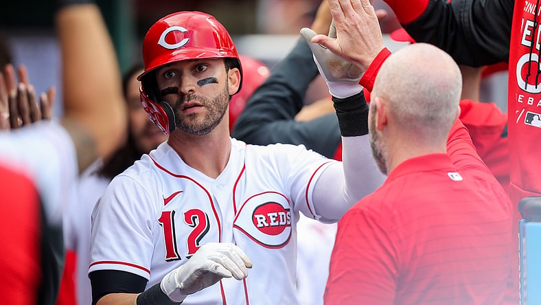 Apr 12, 2022; Cincinnati, Ohio, USA; Cincinnati Reds right fielder Tyler Naquin (12) high fives teammates after hitting a home run against the Cleveland Guardians in the sixth inning at Great American Ball Park. Mandatory Credit: Katie Stratman-USA TODAY Sports