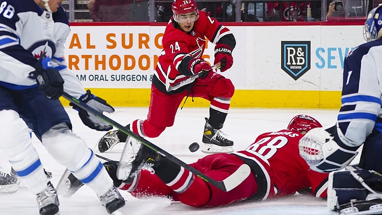 Apr 21, 2022; Raleigh, North Carolina, USA;  Carolina Hurricanes center Seth Jarvis (24) takes a shot against the Winnipeg Jets during the first period at PNC Arena. Mandatory Credit: James Guillory-USA TODAY Sports