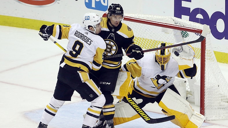 Apr 21, 2022; Pittsburgh, Pennsylvania, USA;  Pittsburgh Penguins goaltender Casey DeSmith (1) makes a glove save as Pens center Evan Rodrigues (9) defends Boston Bruins left wing Erik Haula (56) during the second period at PPG Paints Arena. Mandatory Credit: Charles LeClaire-USA TODAY Sports