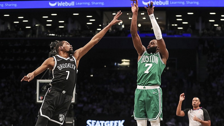 Apr 23, 2022; Brooklyn, New York, USA;  Boston Celtics guard Jaylen Brown (7) takes a three point shot over Brooklyn Nets forward Kevin Durant (7) in the first quarter at Barclays Center. Mandatory Credit: Wendell Cruz-USA TODAY Sports