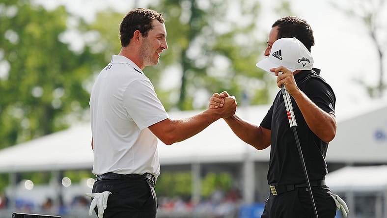 Apr 24, 2022; Avondale, Louisiana, USA; Xander Schauffele (right) embraces Patrick Cantlay (left) on the 18th green during the final round of the Zurich Classic of New Orleans golf tournament. Mandatory Credit: Andrew Wevers-USA TODAY Sports