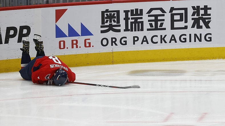 Apr 24, 2022; Washington, District of Columbia, USA; Washington Capitals left wing Alex Ovechkin (8) lies on the ice after being injured while crashing into the boards after being tripped on a breakaway attempt against the Toronto Maple Leafs in the third period at Capital One Arena. Mandatory Credit: Geoff Burke-USA TODAY Sports