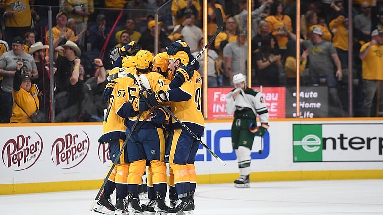 Apr 24, 2022; Nashville, Tennessee, USA; Nashville Predators players celebrate after a goal by defenseman Dante Fabbro (57) during the third period against the Minnesota Wild at Bridgestone Arena. Mandatory Credit: Christopher Hanewinckel-USA TODAY Sports