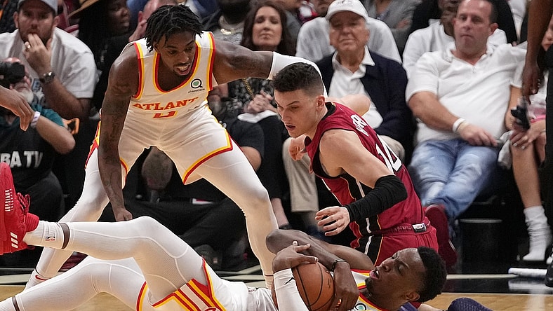 Apr 26, 2022; Miami, Florida, USA; Atlanta Hawks forward Onyeka Okongwu (17) battles Miami Heat guard Tyler Herro (14) for control of a loose ball during the first half in game five of the first round for the 2022 NBA playoffs at FTX Arena. Mandatory Credit: Jasen Vinlove-USA TODAY Sports