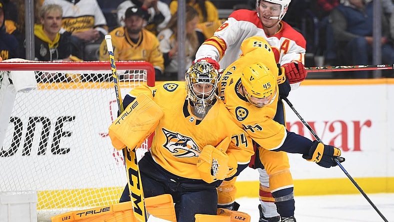 Apr 26, 2022; Nashville, Tennessee, USA; Nashville Predators goaltender Juuse Saros (74) makes a save during the third period against the Calgary Flames at Bridgestone Arena. Mandatory Credit: Christopher Hanewinckel-USA TODAY Sports