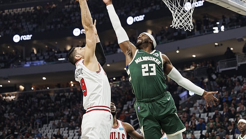 Apr 27, 2022; Milwaukee, Wisconsin, USA;  Milwaukee Bucks guard Wesley Matthews (23) and Chicago Bulls center Nikola Vucevic (9) reach for a rebound during the first quarter during game five of the first round for the 2022 NBA playoffs at Fiserv Forum. Mandatory Credit: Jeff Hanisch-USA TODAY Sports