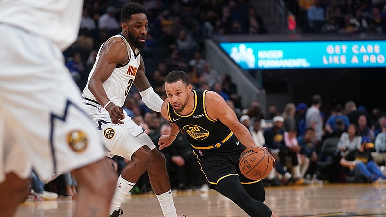 Apr 27, 2022; San Francisco, California, USA; Golden State Warriors guard Stephen Curry (30) dribbles past Denver Nuggets forward Jeff Green (32) in the second quarter during game five of the first round for the 2022 NBA playoffs at Chase Center. Mandatory Credit: Cary Edmondson-USA TODAY Sports