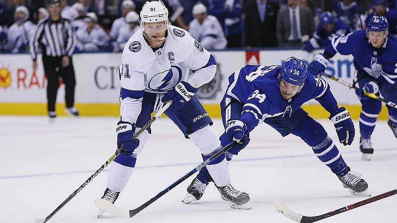 Apr 4, 2019; Toronto, Ontario, CAN; Tampa Bay Lightning forward Steven Stamkos (91) moves the puck against Toronto Maple Leafs forward Auston Matthews (34) at Scotiabank Arena. Tampa Bay defeated Toronto. Mandatory Credit: John E. Sokolowski-USA TODAY Sports