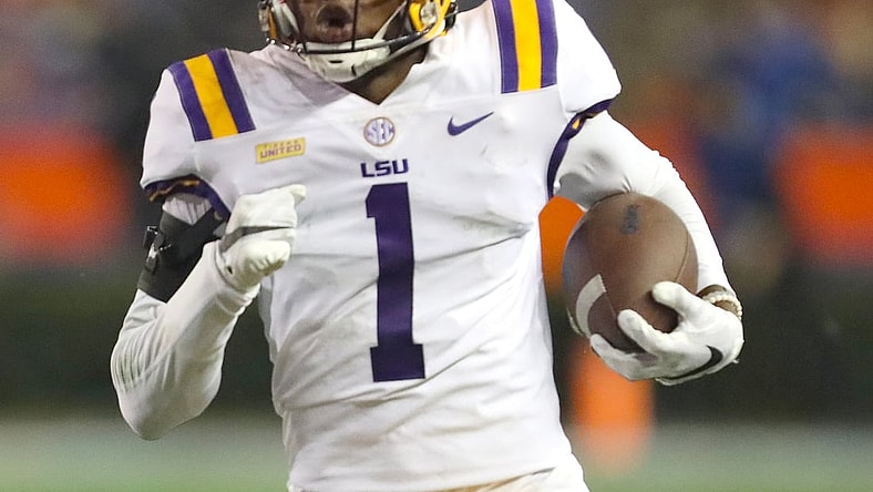 Dec 12, 2020; Gainesville, FL, USA;  LSU defensive back Eli Ricks (1) runs with the ball after making an interception during a game against the Florida Gators  at Ben Hill Griffin Stadium in Gainesville, Fla. Dec. 12, 2020.   Mandatory Credit: Brad McClenny-USA TODAY NETWORK