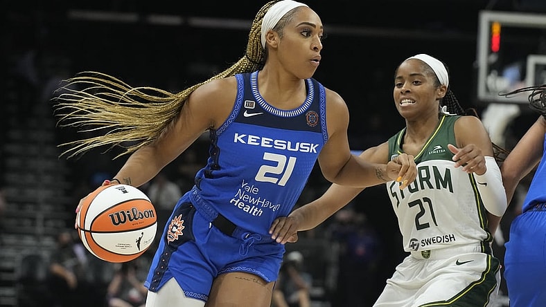 Aug 12, 2021; Phoenix, Arizona, USA; Connecticut Sun guard/forward DiJonai Carrington (left) drives against Seattle Storm guard Jordin Canada (right) in the second half during the Inaugural WNBA Commissioners Cup Championship Game at Footprint Center. Mandatory Credit: Rick Scuteri-USA TODAY Sports
