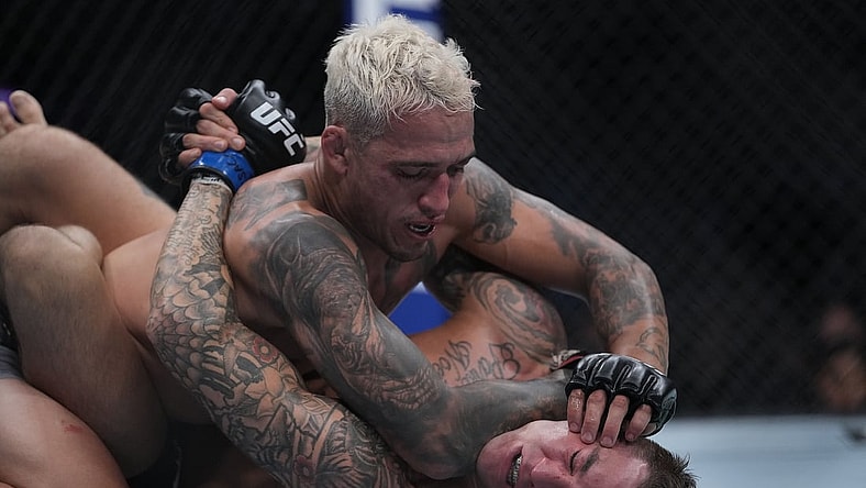Dec 11, 2021; Las Vegas, Nevada, USA; Charles Oliveira pins Dustin Poirier to the mat during UFC 269 at T-Mobile Arena. Mandatory Credit: Stephen R. Sylvanie-USA TODAY Sports