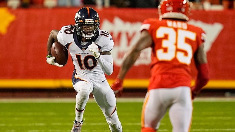 Dec 5, 2021; Kansas City, Missouri, USA; Denver Broncos wide receiver Jerry Jeudy (10) runs the ball as Kansas City Chiefs cornerback Charvarius Ward (35) defends during the second half at GEHA Field at Arrowhead Stadium. Mandatory Credit: Jay Biggerstaff-USA TODAY Sports