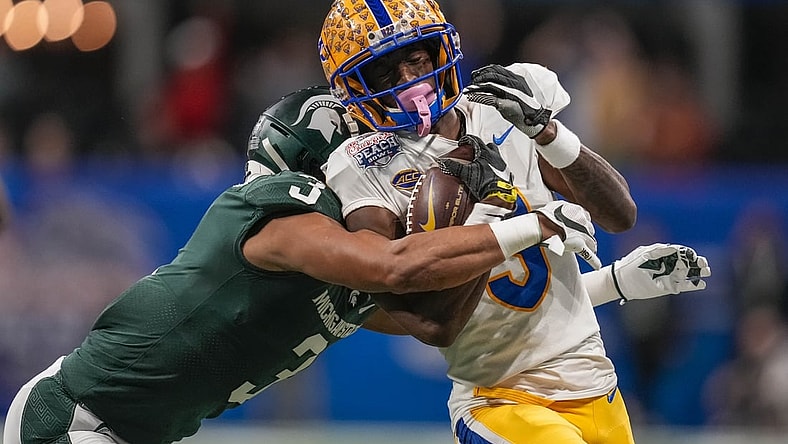 Dec 30, 2021; Atlanta, GA, USA; Pittsburgh Panthers wide receiver Jordan Addison (3) is tackled by Michigan State Spartans safety Xavier Henderson (3) after a long pass reception during the first half during the 2021 Peach Bowl at Mercedes-Benz Stadium. Mandatory Credit: Dale Zanine-USA TODAY Sports