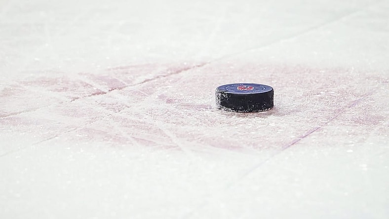 Jan 29, 2022; Calgary, Alberta, CAN; General view of the hockey puck during the third period between the Calgary Flames and the Vancouver Canucks at Scotiabank Saddledome. Mandatory Credit: Sergei Belski-USA TODAY Sports