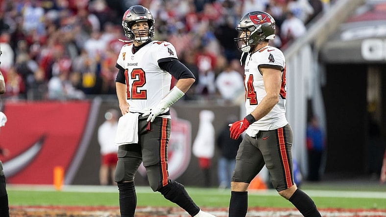 Jan 23, 2022; Tampa, Florida, USA; Tampa Bay Buccaneers quarterback Tom Brady (12) walks off the field looking at the scoreboard during the second half against the Los Angeles Rams during a NFC Divisional playoff football game at Raymond James Stadium. Mandatory Credit: Matt Pendleton-USA TODAY Sports