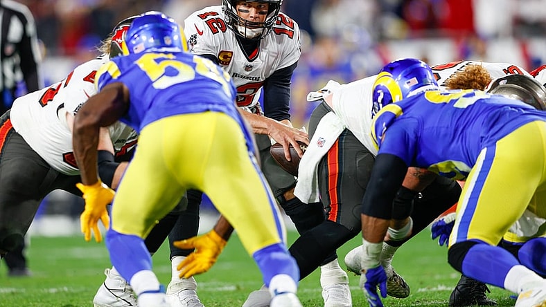 Jan 23, 2022; Tampa, Florida, USA; Tampa Bay Buccaneers quarterback Tom Brady (12) takes the snap before running back Leonard Fournette (7) (not pictured) scored a touchdown in the fourth quarter against the Los Angeles Rams during the NFC Divisional playoff football game at Raymond James Stadium. Mandatory Credit: Nathan Ray Seebeck-USA TODAY Sports