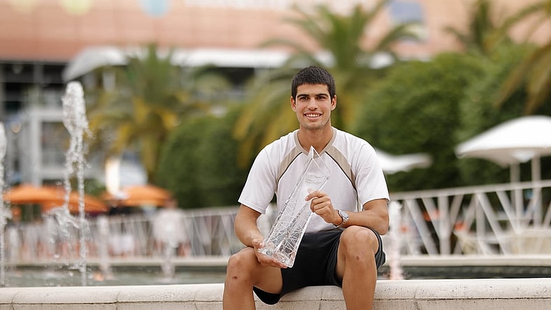 Apr 3, 2022; Miami Gardens, FL, USA; Carlos Alcaraz (ESP) poses for a portrait while holding the Butch Buchholz Championship Trophy after winning the men's singles final in the Miami Open at Hard Rock Stadium. Mandatory Credit: Geoff Burke-USA TODAY Sports