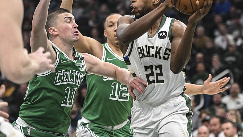Apr 7, 2022; Milwaukee, Wisconsin, USA;  Milwaukee Bucks forward Khris Middleton (22) gets pressure from Boston Celtics guard Payton Pritchard (11) in the first quarter at Fiserv Forum. Mandatory Credit: Benny Sieu-USA TODAY Sports