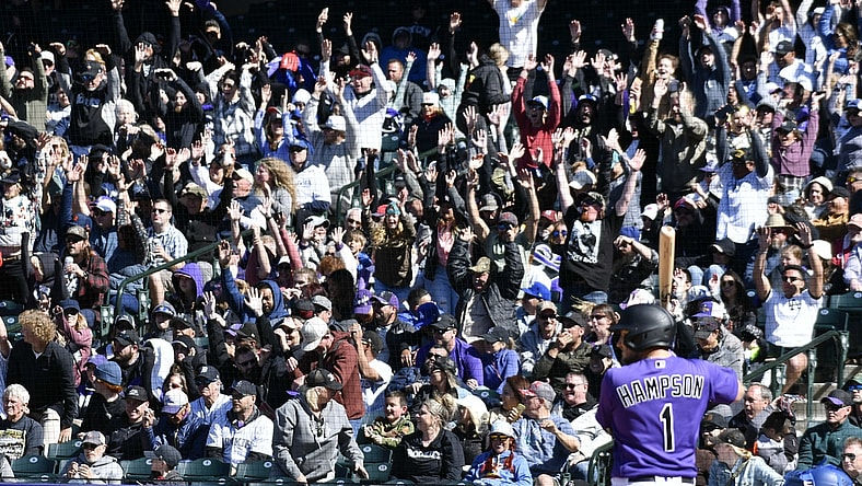 Apr 10, 2022; Denver, Colorado, USA; Colorado Rockies fans do the wave as Colorado Rockies center fielder Garrett Hampson (1) stands in the batters box during the sixth inning against the Los Angeles Dodgers at Coors Field. Mandatory Credit: John Leyba-USA TODAY Sports