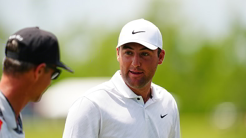 Apr 22, 2022; Avondale, Louisiana, USA; Scottie Scheffler talks to his caddie on the ninth hole green during the second round of the Zurich Classic of New Orleans golf tournament. Mandatory Credit: Andrew Wevers-USA TODAY Sports