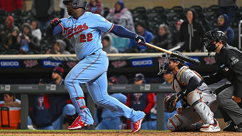 Apr 26, 2022; Minneapolis, Minnesota, USA; Minnesota Twins first baseman Miguel Sano (22) hits a single in the ninth inning against the Detroit Tigers at Target Field. Mandatory Credit: Nick Wosika-USA TODAY Sports