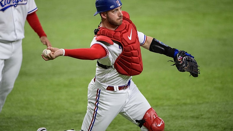 Apr 28, 2022; Arlington, Texas, USA; Texas Rangers catcher Mitch Garver (18) throws out Houston Astros right fielder Chas McCormick (not pictured) during the first inning at Globe Life Field. Mandatory Credit: Jerome Miron-USA TODAY Sports