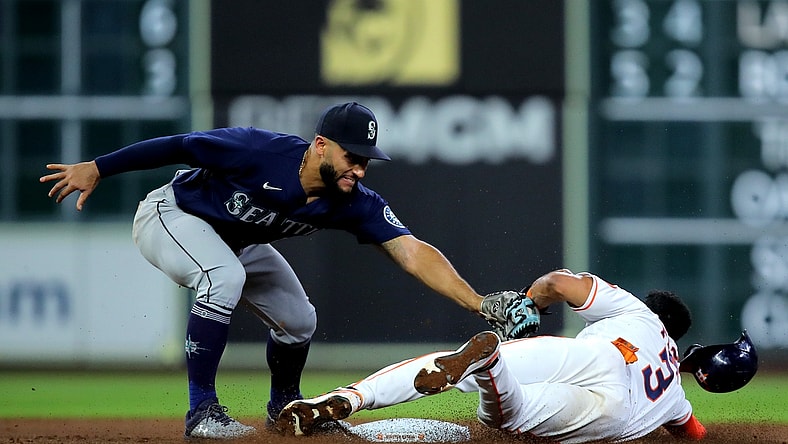 May 3, 2022; Houston, Texas, USA; Houston Astros shortstop Jeremy Pena (3) slides into second base while beating the tag by Seattle Mariners third baseman Abraham Toro (13) during the third inning at Minute Maid Park. Mandatory Credit: Erik Williams-USA TODAY Sports