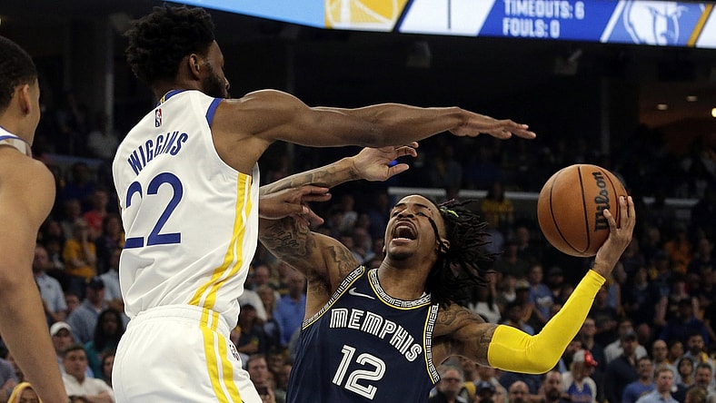 May 3, 2022; Memphis, Tennessee, USA; Memphis Grizzlies guard Ja Morant (12) drives to the basket as Golden State Warriors forward Andrew Wiggins (22) defends during the first half in game two of the second round for the 2022 NBA playoffs at FedExForum. Mandatory Credit: Petre Thomas-USA TODAY Sports