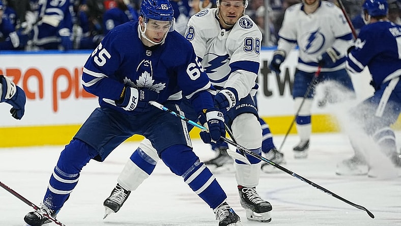 May 4, 2022; Toronto, Ontario, CAN; Tampa Bay Lightning defenseman Mikhail Sergachev (98) tries to knock the puck away from Toronto Maple Leafs forward Ilya Mikheyev (65) during the first period of game two of the first round of the 2022 Stanley Cup Playoffs at Scotiabank Arena. Mandatory Credit: John E. Sokolowski-USA TODAY Sports
