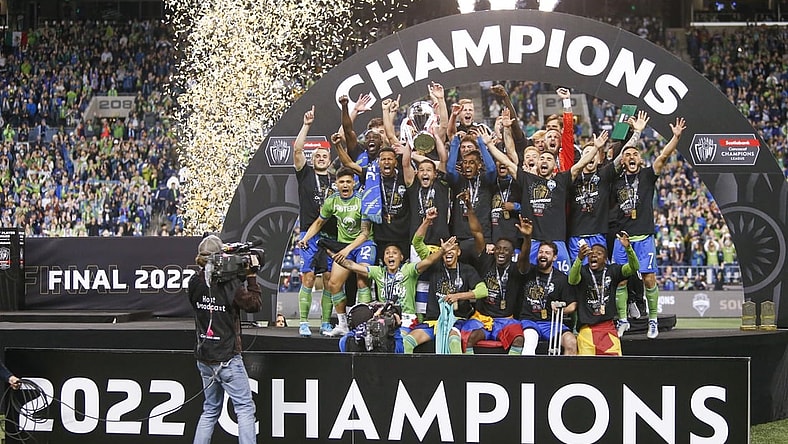May 4, 2022; Seattle, WA, USA; Seattle Sounders FC players, including midfielder Nicolas Lodeiro (10, holding trophy) celebrate after defeating Pumas 3-0 in the second leg of the Concacaf Champions League Final at Lumen Field. Mandatory Credit: Joe Nicholson-USA TODAY Sports