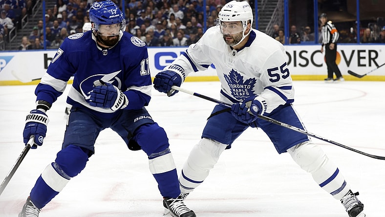 May 6, 2022; Tampa, Florida, USA; Toronto Maple Leafs defenseman Mark Giordano (55) and Tampa Bay Lightning left wing Alex Killorn (17) fight to control the puck during the first period of game three of the first round of the 2022 Stanley Cup Playoffs against the Tampa Bay Lightning at Amalie Arena. Mandatory Credit: Kim Klement-USA TODAY Sports